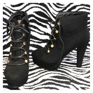 Black booties with gold buckles.